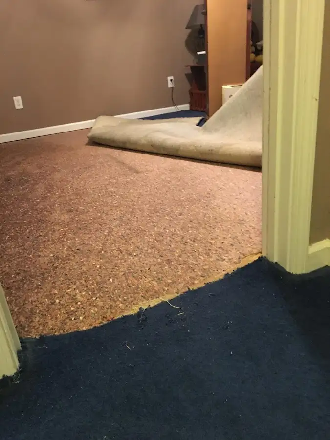 Carpet pad removal revealing water damage during Drying & Dehumidification in Sand Springs